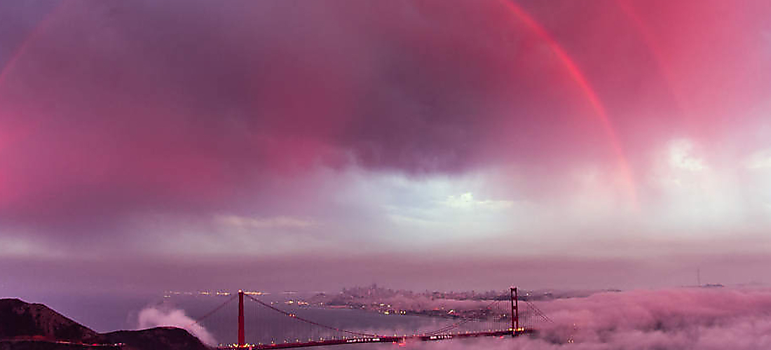 Golden Gate Bridge beneath clouds and a rainbow